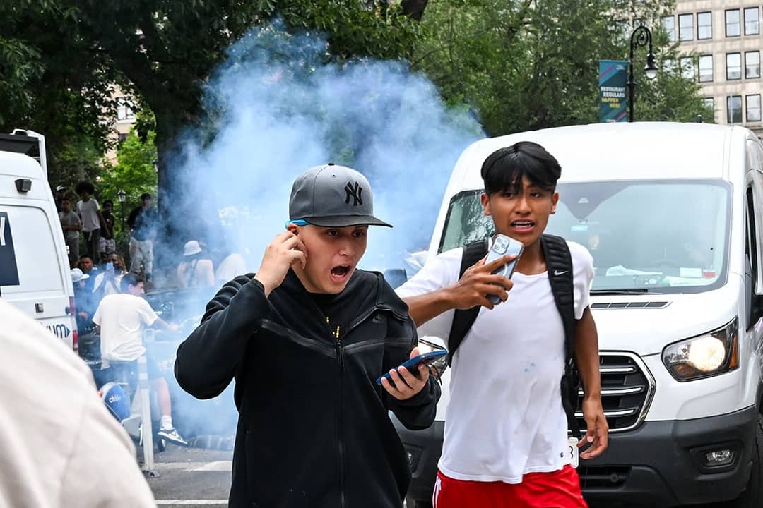 Teenagers run away after an unknown explosive device is set off during popular Twitch streamer Kai Cenat's event in New York City on August 4, 2023.
